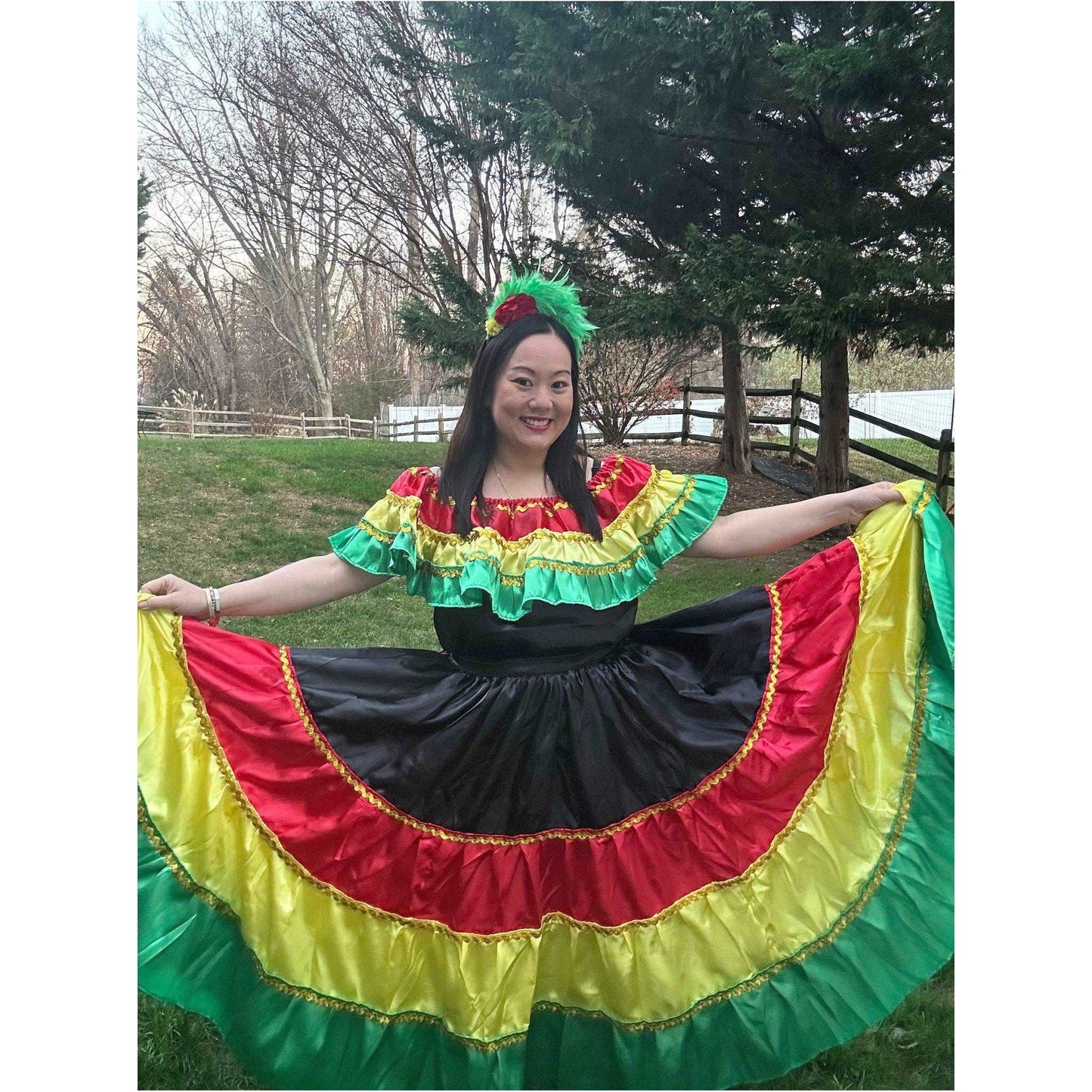 a beautiful woman sitting on top of a colorful umbrella 