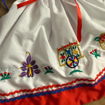 Traditional embroidered skirt and red trim detail